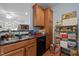 Functional kitchen with wood cabinets, black dishwasher, and double basin sink at 712 Portstewart Dr, Cary, NC 27519