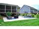 Inviting backyard with a covered porch, swing set, and relaxing seating areas, perfect for entertaining at 738 Aspenwood Dr, Graham, NC 27253