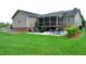 Spacious backyard with a screened porch and patio area, perfect for outdoor entertaining at 738 Aspenwood Dr, Graham, NC 27253