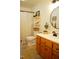 Bathroom featuring a wood vanity, decorative shelving, and shower for a clean and functional space at 738 Aspenwood Dr, Graham, NC 27253