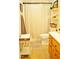 Bathroom featuring a wood vanity, decorative shelving, and shower for a clean and functional space at 738 Aspenwood Dr, Graham, NC 27253