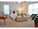 Serene bedroom featuring two windows, a comfortable bed, and neutral decor for a relaxing ambiance at 738 Aspenwood Dr, Graham, NC 27253
