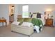 Bright bedroom with a window, comfortable bedding, stylish pillows, and an ensuite bathroom at 738 Aspenwood Dr, Graham, NC 27253