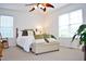 A comfortable bedroom with natural light, complemented by a ceiling fan and tasteful decor at 738 Aspenwood Dr, Graham, NC 27253