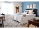 Bright bedroom with a blue accent wall, comfortable bed, and stylish decor for a modern feel at 738 Aspenwood Dr, Graham, NC 27253