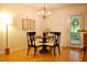 Cozy dining room featuring a round table, decorative chandelier, and access to the outdoor living space at 738 Aspenwood Dr, Graham, NC 27253