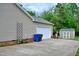 Home exterior featuring a spacious driveway, shed, garage, and neat landscaping at 738 Aspenwood Dr, Graham, NC 27253