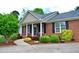 Inviting brick home with manicured landscaping and a walkway to the front door at 738 Aspenwood Dr, Graham, NC 27253