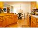 Open-concept kitchen with wood cabinets seamlessly flowing into the dining area at 738 Aspenwood Dr, Graham, NC 27253