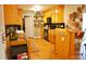 Functional kitchen with sleek black appliances and wood cabinetry at 738 Aspenwood Dr, Graham, NC 27253