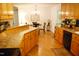 Efficient kitchen design with wood cabinets leading to a dining area at 738 Aspenwood Dr, Graham, NC 27253
