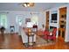Inviting living room featuring a decorative rug, ceiling fan and a fireplace flanked by built-in shelving at 738 Aspenwood Dr, Graham, NC 27253