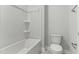 Bright bathroom featuring a sleek white tub and shower combination and modern toilet at 745 Aristocrat Ln, Knightdale, NC 27545