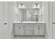 Bathroom featuring a double vanity, modern fixtures, and a view of the walk-in shower at 745 Aristocrat Ln, Knightdale, NC 27545
