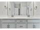 Bathroom with dual sinks, modern fixtures, and large vanity mirrors at 745 Aristocrat Ln, Knightdale, NC 27545