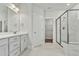 Bathroom featuring a double vanity, a tiled floor and a walk-in shower with glass door at 745 Aristocrat Ln, Knightdale, NC 27545