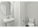 A bathroom with a pedestal sink and a toilet at 745 Aristocrat Ln, Knightdale, NC 27545