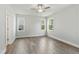 Bright bedroom with two windows offering natural light, wood floors, light gray walls and a ceiling fan at 745 Aristocrat Ln, Knightdale, NC 27545