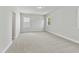 Spacious bedroom with plush carpeting, neutral paint and natural light from the windows at 745 Aristocrat Ln, Knightdale, NC 27545