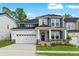 Charming two-story home with a manicured lawn, a two car garage, and stone accents at 745 Aristocrat Ln, Knightdale, NC 27545