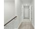 Bright hallway with neutral carpet, white walls, and access to multiple rooms on the second floor at 745 Aristocrat Ln, Knightdale, NC 27545