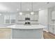 Modern kitchen with stainless steel appliances and a large central island at 745 Aristocrat Ln, Knightdale, NC 27545