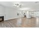 Open concept living room with fireplace flowing into a kitchen with an island and white cabinets at 745 Aristocrat Ln, Knightdale, NC 27545