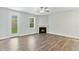 Bright living room featuring a fireplace, wood floors, light gray walls, and an exit door at 745 Aristocrat Ln, Knightdale, NC 27545