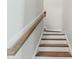 Stairway with wood stairs, white risers, wood handrail and white trim at 745 Aristocrat Ln, Knightdale, NC 27545