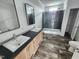 Bathroom with double sink vanity, spacious shower, and stylish dark gray tile at 765 Whitley Rd, Middlesex, NC 27557