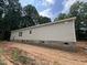 Single-story home with neutral siding, window and brick foundation; set amongst trees at 765 Whitley Rd, Middlesex, NC 27557