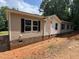 Charming single-story home featuring neutral siding, dark shutters, and a classic brick foundation at 765 Whitley Rd, Middlesex, NC 27557