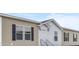 Inviting exterior featuring beige siding, black shutters, and a covered entryway at 765 Whitley Rd, Middlesex, NC 27557