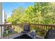 Inviting balcony with two chairs and small table, offering serene views of the surrounding trees at 7838 Spungold St, Raleigh, NC 27617