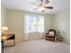 Inviting bedroom featuring a ceiling fan, comfortable armchair, and natural light from a large window at 7838 Spungold St, Raleigh, NC 27617