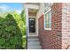 Charming front door with wreath, brick accents, and stone steps leading to the entrance at 7838 Spungold St, Raleigh, NC 27617