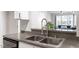 Kitchen featuring a stainless steel sink, granite countertops and open to living area at 7838 Spungold St, Raleigh, NC 27617