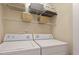 Functional laundry area featuring a washer and dryer, wire shelves, and ample storage space at 7838 Spungold St, Raleigh, NC 27617