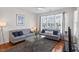 Bright living room with neutral walls, large windows, and comfortable seating arrangement at 7838 Spungold St, Raleigh, NC 27617