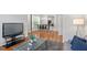 Open living space with hardwood floors, a flatscreen TV, and an adjacent dining area at 7838 Spungold St, Raleigh, NC 27617
