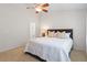 Relaxing main bedroom showcasing a king-sized bed, ceiling fan, and ensuite bathroom access at 7838 Spungold St, Raleigh, NC 27617