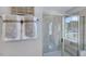 Modern bathroom featuring a tiled shower with a glass door and a convenient built-in bench at 8724 Wardle Ct, Wake Forest, NC 27587