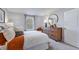 Bright bedroom featuring a dresser with round mirror, a comfortable bed, and a window with natural light at 8724 Wardle Ct, Wake Forest, NC 27587