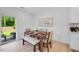 Bright dining area with wood table, comfortable seating, light walls and a view of the outdoors at 8724 Wardle Ct, Wake Forest, NC 27587