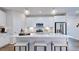 Bright and modern kitchen with a large island, stainless appliances, and stylish pendant lighting at 8724 Wardle Ct, Wake Forest, NC 27587