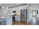 Modern kitchen featuring white cabinets, stainless steel appliances, and a stylish backsplash at 8724 Wardle Ct, Wake Forest, NC 27587