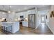 Well-lit kitchen with stainless appliances, a center island with seating, and wood flooring throughout at 8724 Wardle Ct, Wake Forest, NC 27587