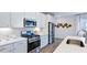 Bright kitchen featuring white cabinets, stainless steel appliances, and modern countertops at 8724 Wardle Ct, Wake Forest, NC 27587
