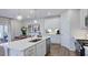 Open kitchen with a large island, stainless appliances, modern lighting, and adjacent dining area at 8724 Wardle Ct, Wake Forest, NC 27587
