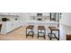 Beautiful kitchen featuring white cabinets, stainless steel appliances and a large island with counter seating at 8724 Wardle Ct, Wake Forest, NC 27587